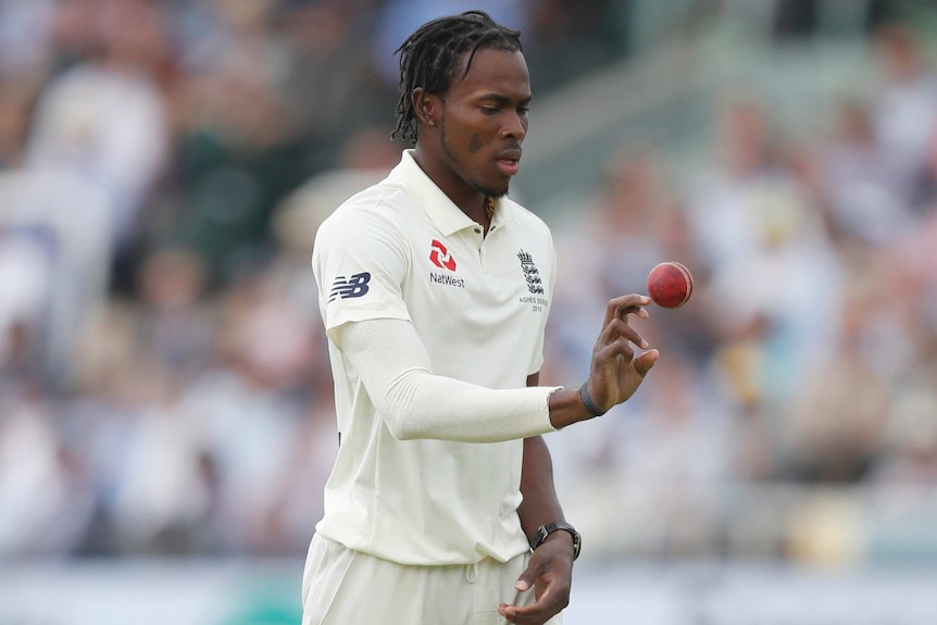 Jofra Archer throws a cricket ball up to himself