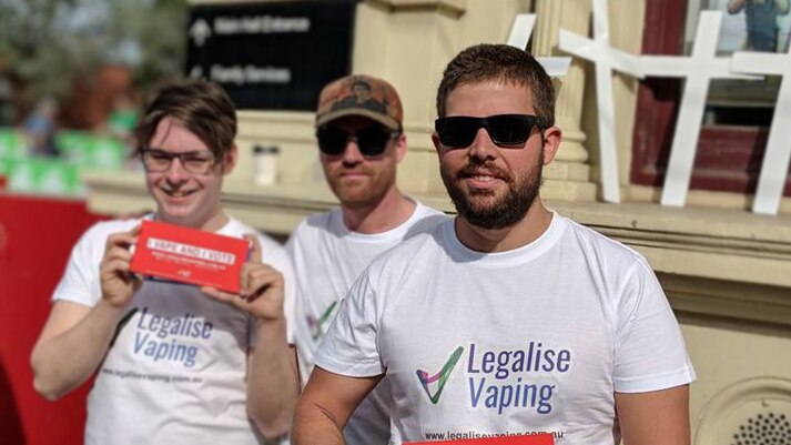 Legalise Vaping Australia's campaign manager Brian Marlow is holding an I Vape And Vote sign