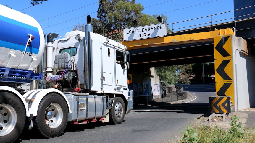 A truck is driven towards a bridge in Footscray.