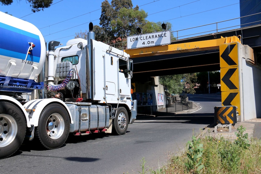 A truck is driven towards a bridge in Footscray.