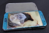 close up photo of a smartphone with melted screen and body of phone exploded apart