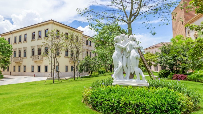 A recreation of the city of Verona with a statue of three women, known as the three graces.