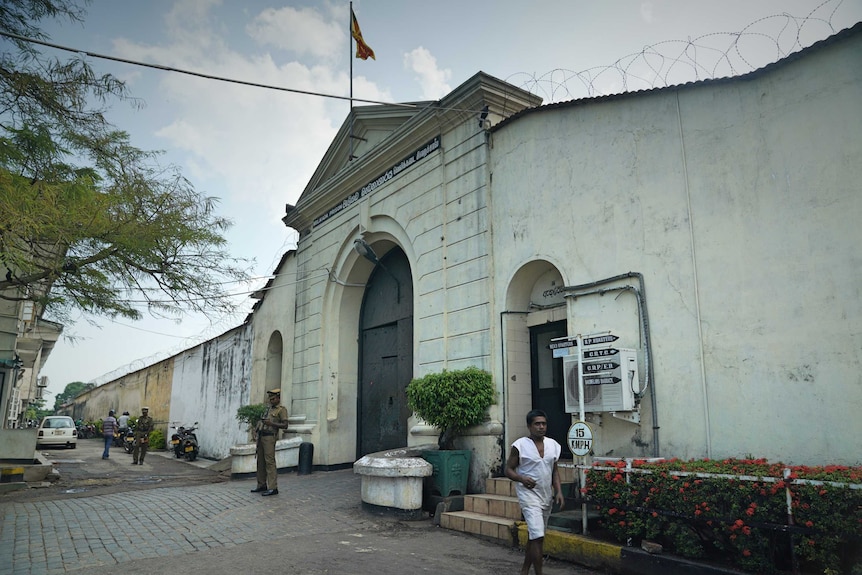 The stone gate covered in barbed wire for Colombo's Welikada prison