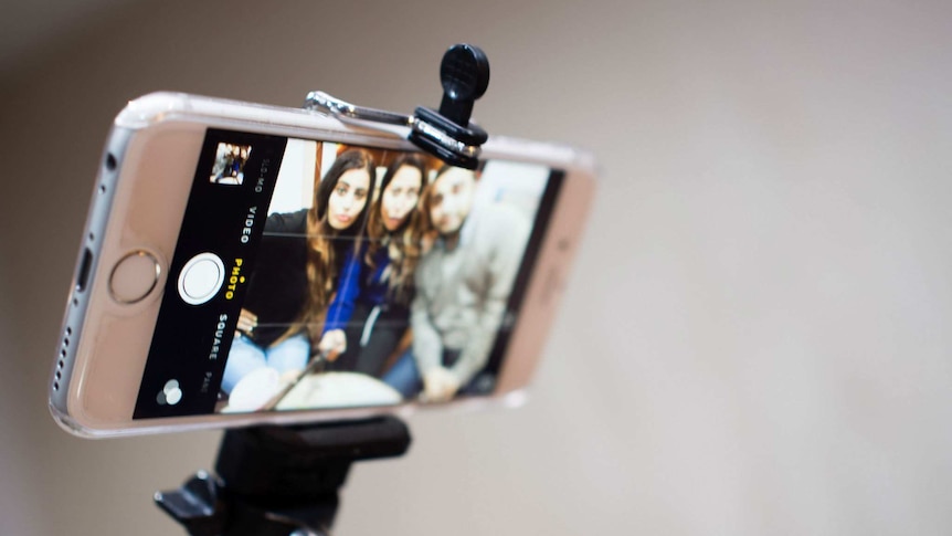 An iPhone on a selfie stick.