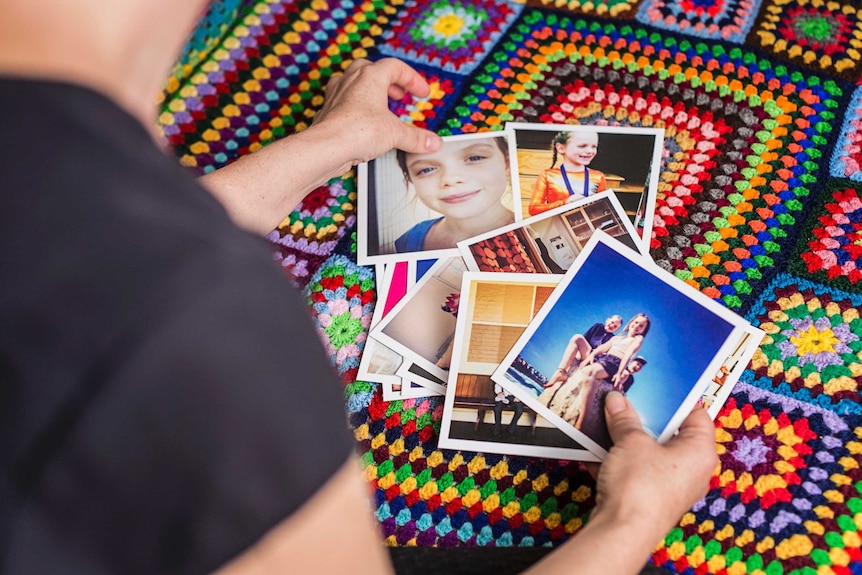 Christy Newman looks through photos of her two children.