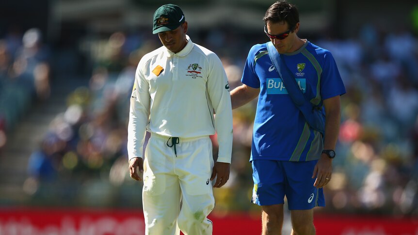 Khawaja trudges off after picking up an injury