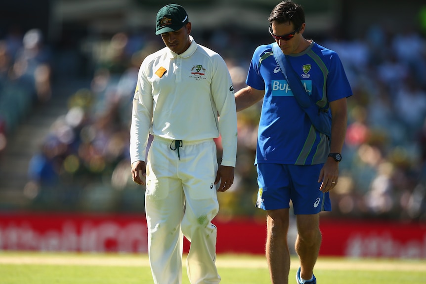 Australia's Usman Khawaja leaves WACA with an injury on day two of the second Test v New Zealand.