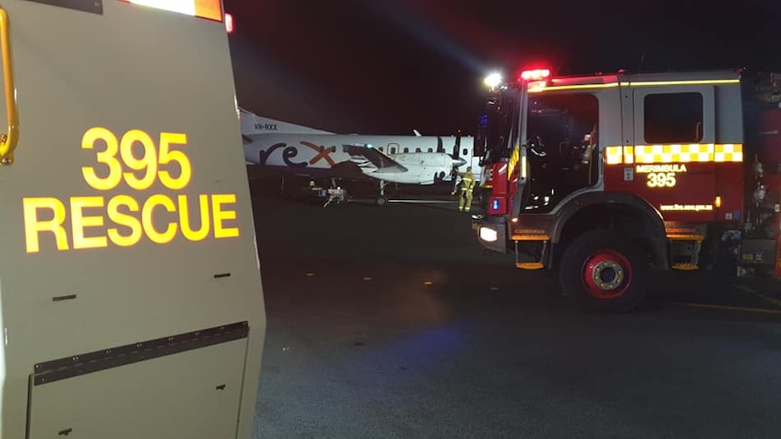 Firetrucks and emergency vehicles on the tarmac at a regional airport