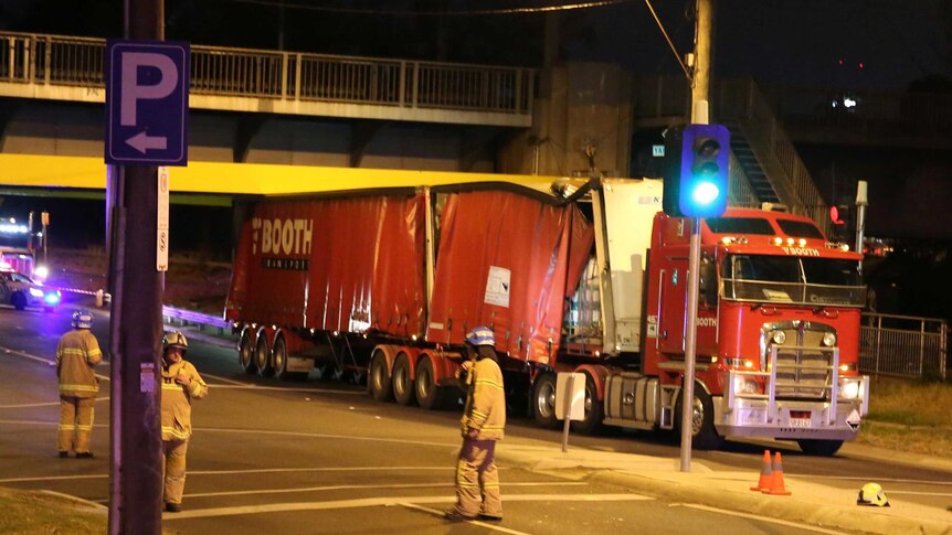 A truck gets stuck under an overpass across Alexandra Avenue at South Yarra in Melbourne.