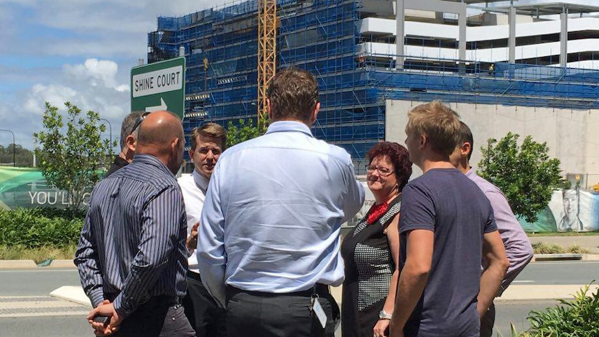 Huddle of people at a building site