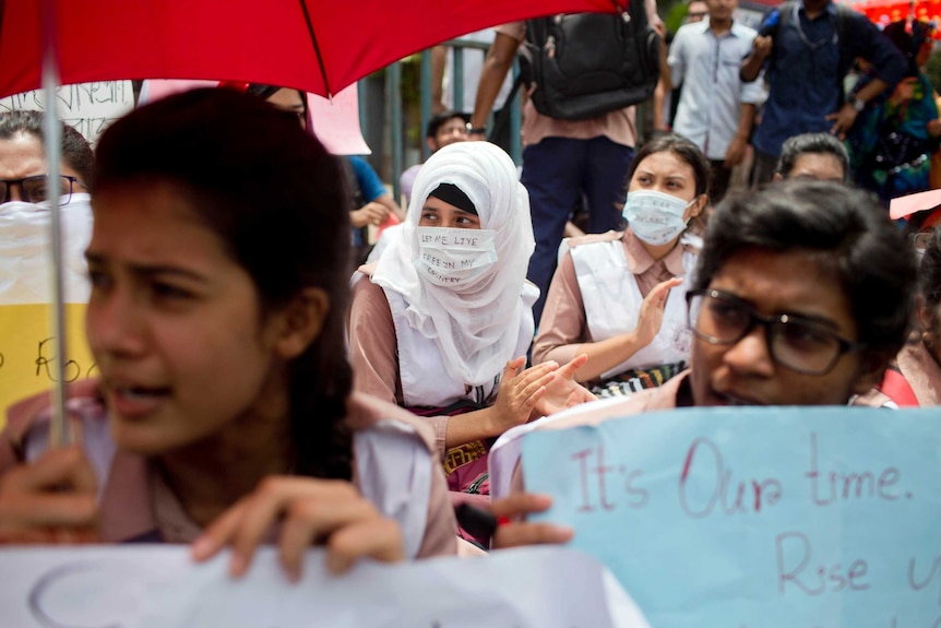 Students are seen carrying banners during a protest.