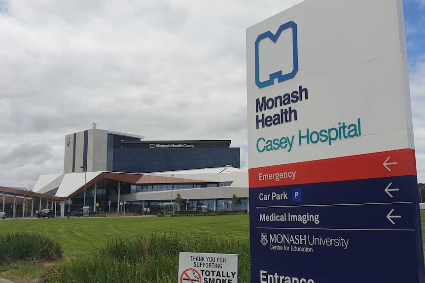 The sign outside Casey Hospital with the hospital in the distance.