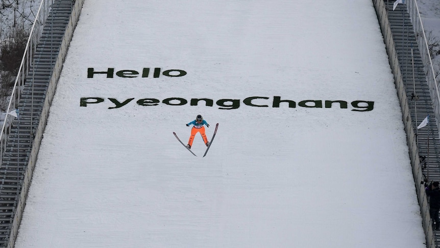 A ski jumper flies through the air after jumping off the Pyeongchang ramp.