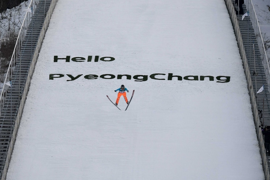 A ski jumper flies through the air after jumping off the Pyeongchang ramp.