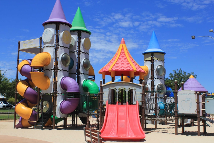 A brightly coloured playground featuring slides and climbing towers and tunnels