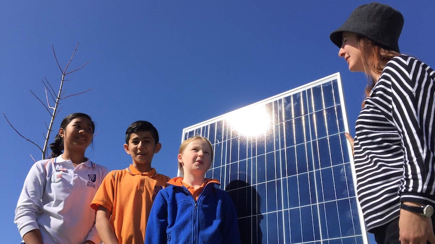Students at Bonner Primary School with one of the school's solar panels