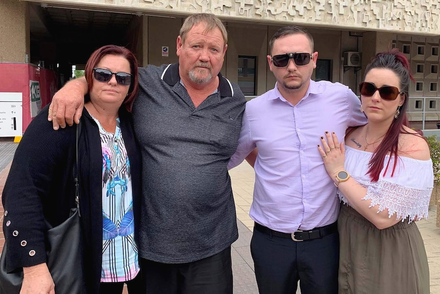 Father Danny McCabe (L) with his family outside court
