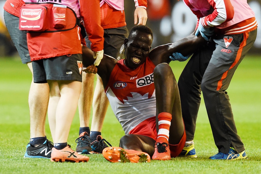 Aliir Aliir of the Swans taken off with injury