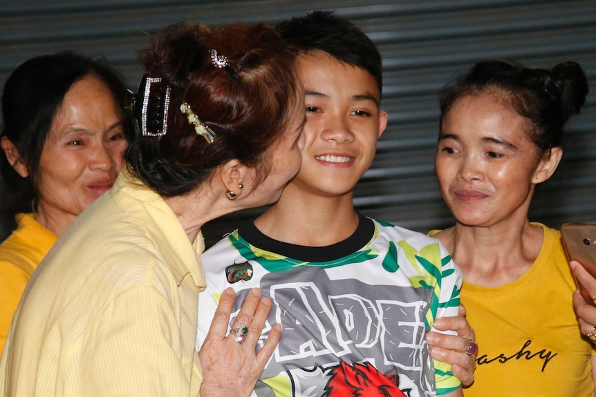 Relatives of Duangpetch Promthep greet him as he arrives home in the Mae Sai district.