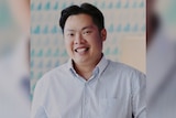 A man named Luke Tham Shengen wearing a business shirt and smiling.