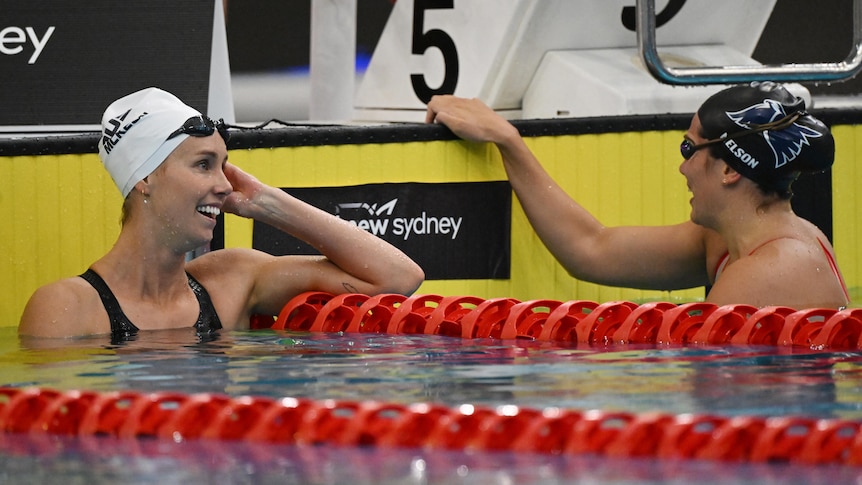 Emma McKeon smiles at Geat Nelson while they are in the pool