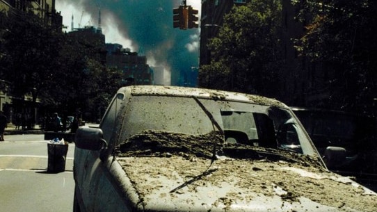 A car is covered in ash and dust as smoke rises from the World Trade Centre site in New York City on September 11, 2001.