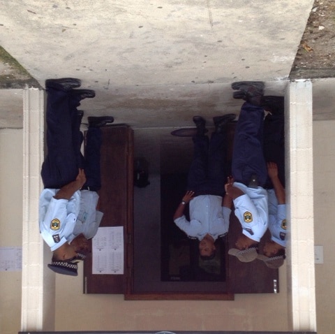 Police stand outside a Nauru courthouse as asylum seekers accused of rioting in a detention centre attend a pre-trial hearing.