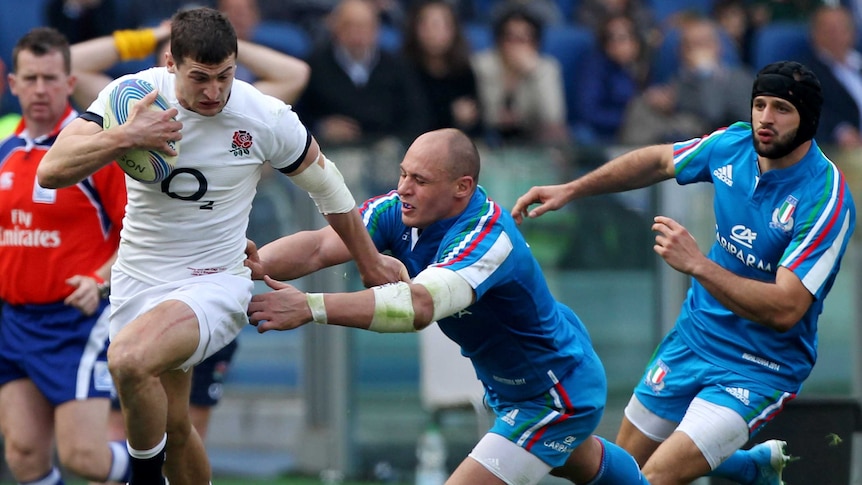 England's Jonny May is tackled by Italy's Sergio Parisse in their Six Nations game in Rome.