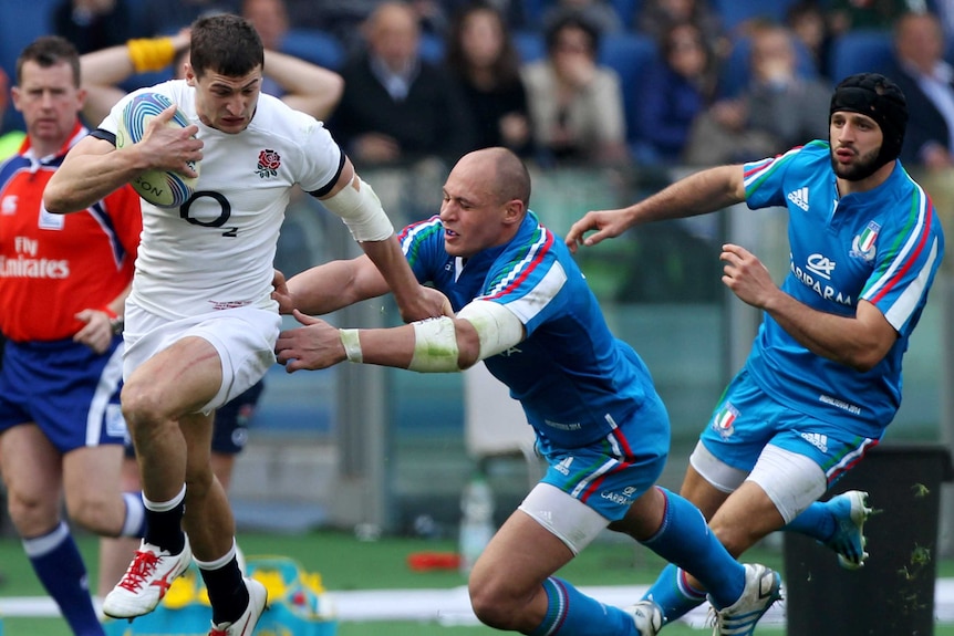 England's Jonny May is tackled by Italy's Sergio Parisse in their Six Nations game in Rome.