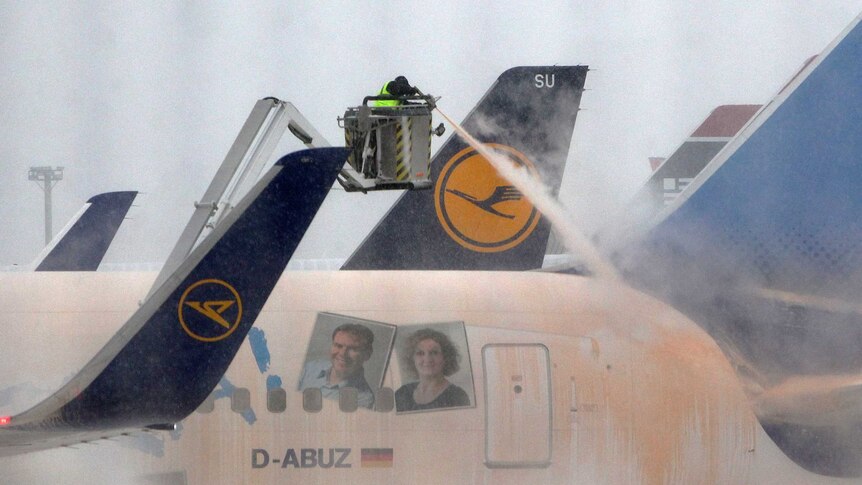 Airport worker de-ices German plane