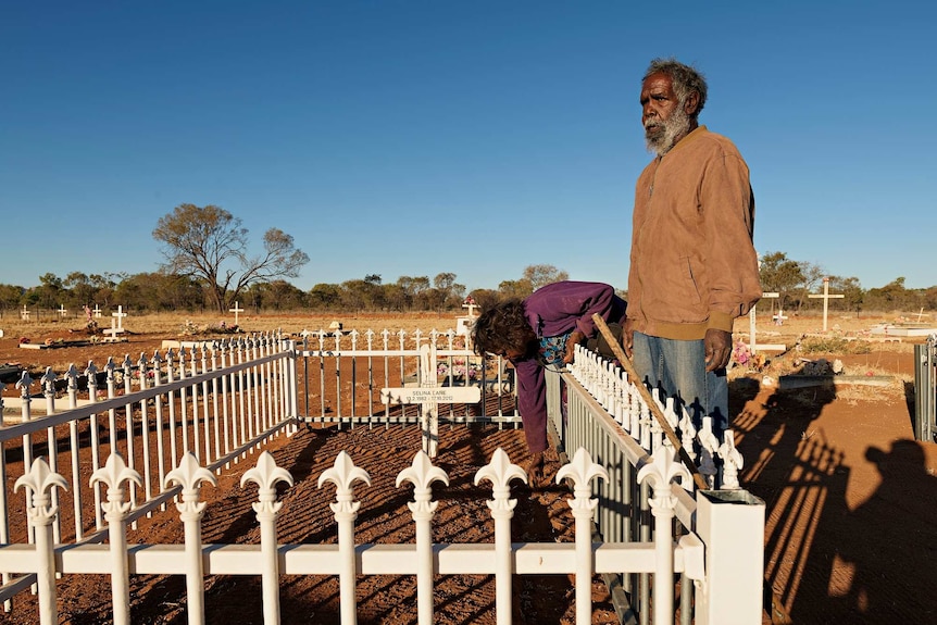 Joseph and Ann Lane stands beside the grave of their daughter Selina at the Haasts Bluff graveyard.