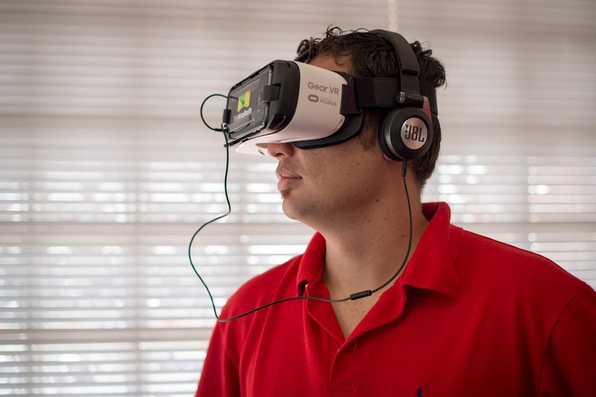 Benjamin Farkas wears a virtual reality headset, taking him on a tour of far north Queensland and its education facilities.