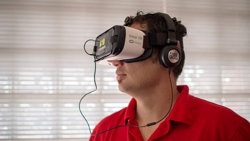 Benjamin Farkas wears a virtual reality headset, taking him on a tour of far north Queensland and its education facilities.