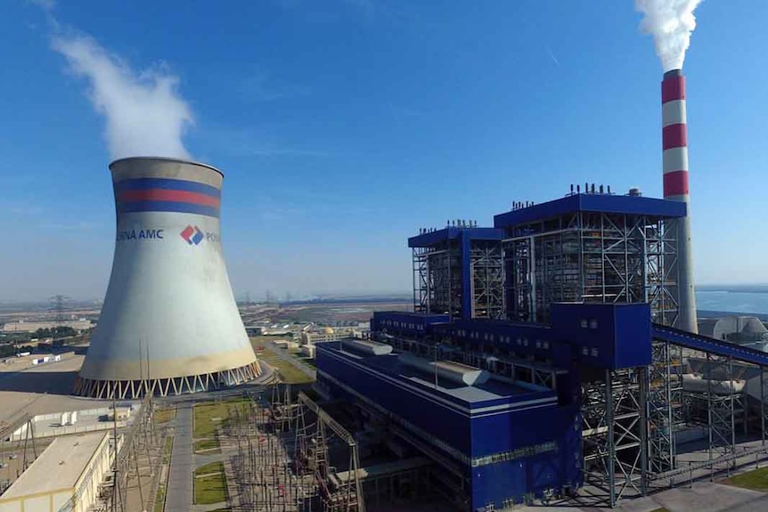 smoke coming out of the silo and smoke stack of a power plant