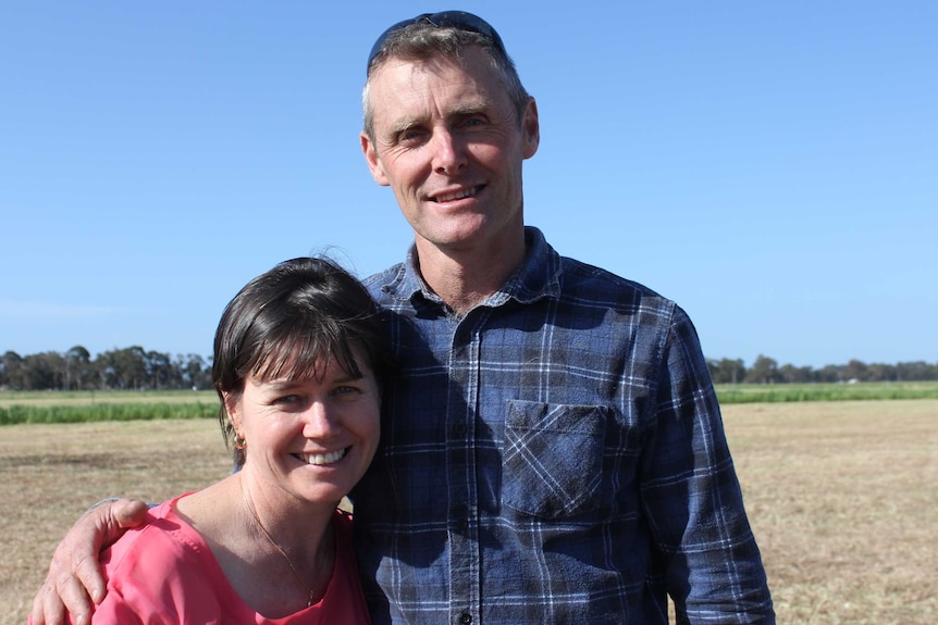 Jo and Brett Milner stand in freshly cut paddock at their property