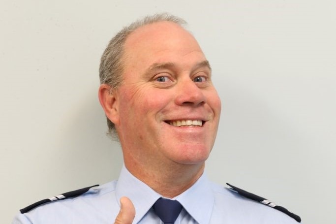 Queensland Police Service Senior Constable David Masters smiles and gives the thumbs up.