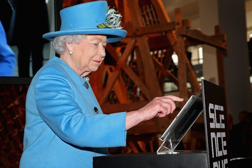 Queen Elizabeth posts her first tweet at London's Science Museum on Friday 24 October, 2014.