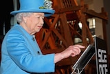 Queen Elizabeth posts her first tweet at London's Science Museum on Friday 24 October, 2014.