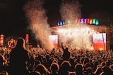 The festival crowd at Falls Festival, facing the stage at night time.