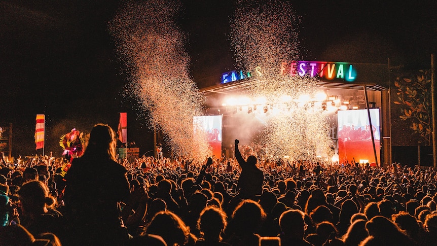 The festival crowd at Falls Festival, facing the stage at night time.
