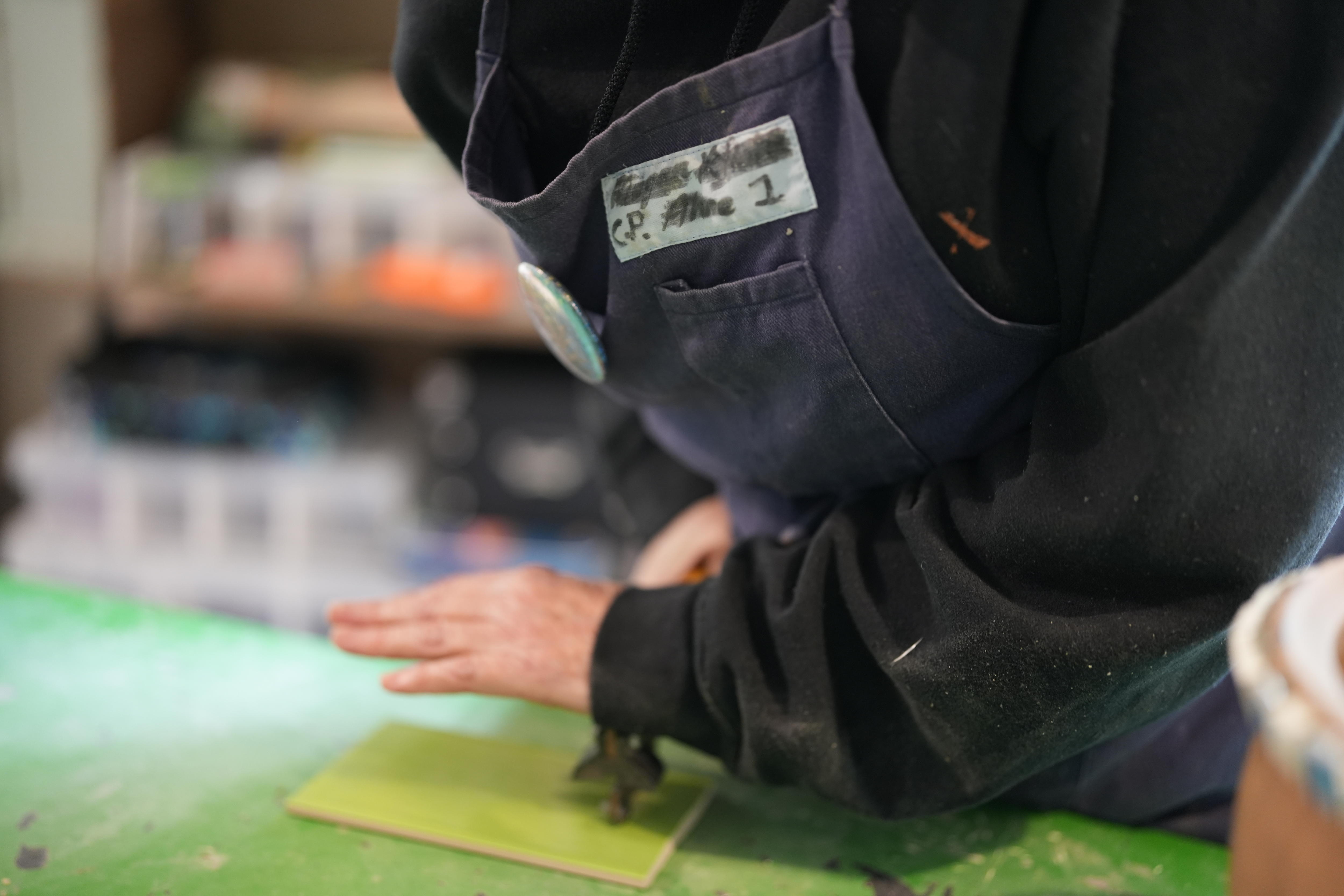 Tiles being cut close up of hand
