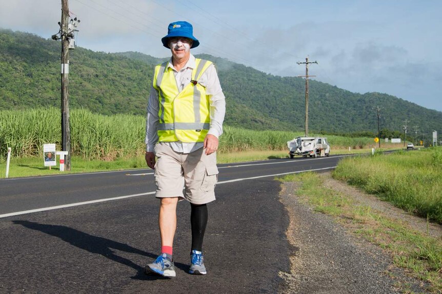 Dr Bill Boyd walks alongside the Bruce Highway south of Cairns.