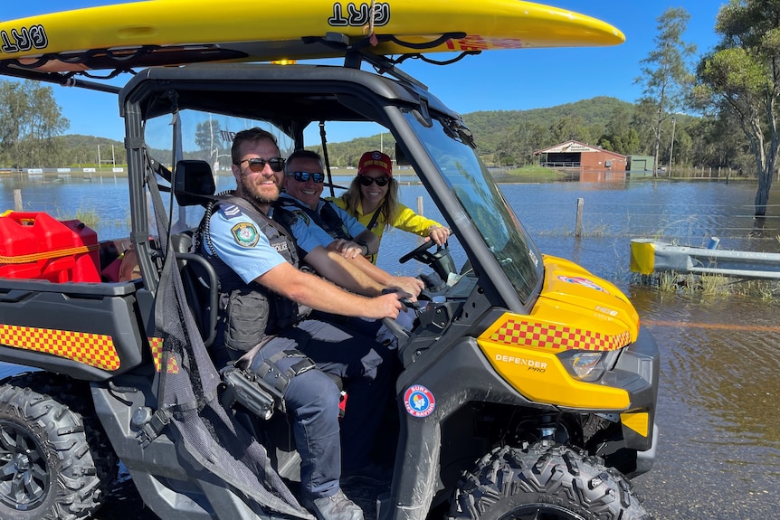 Two police and a surf life saving volunteer on an all terrain vehicle