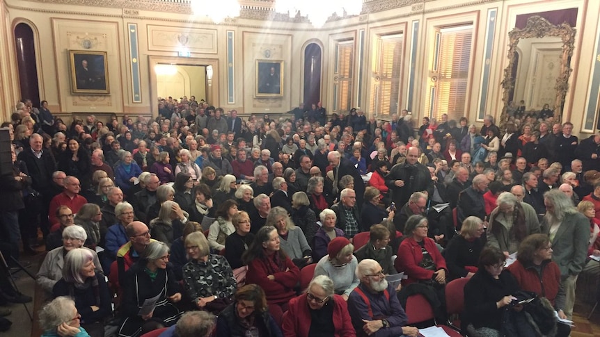 Packed Hobart Town Hall at public meeting on high rise building.