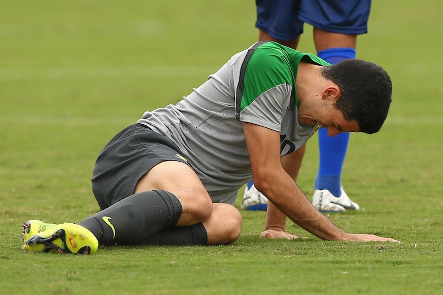 Tom Rogic of the Socceroos falls to the ground during a training match against Parana Clube.