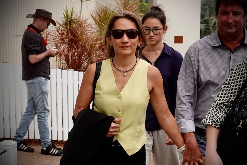 A woman walks at the Darwin Local Court. 