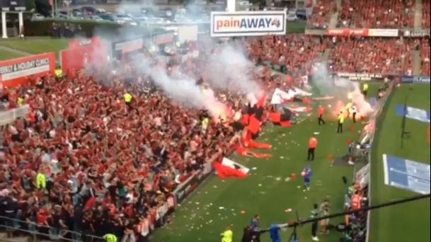 Western Sydney Wanderers fans throw flares into the stadium at the A-League Sydney Derby match.