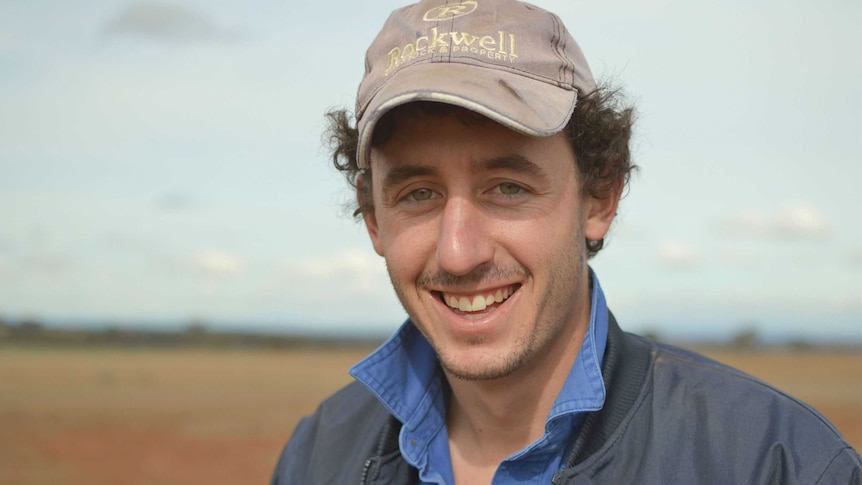 A man smiles at the camera