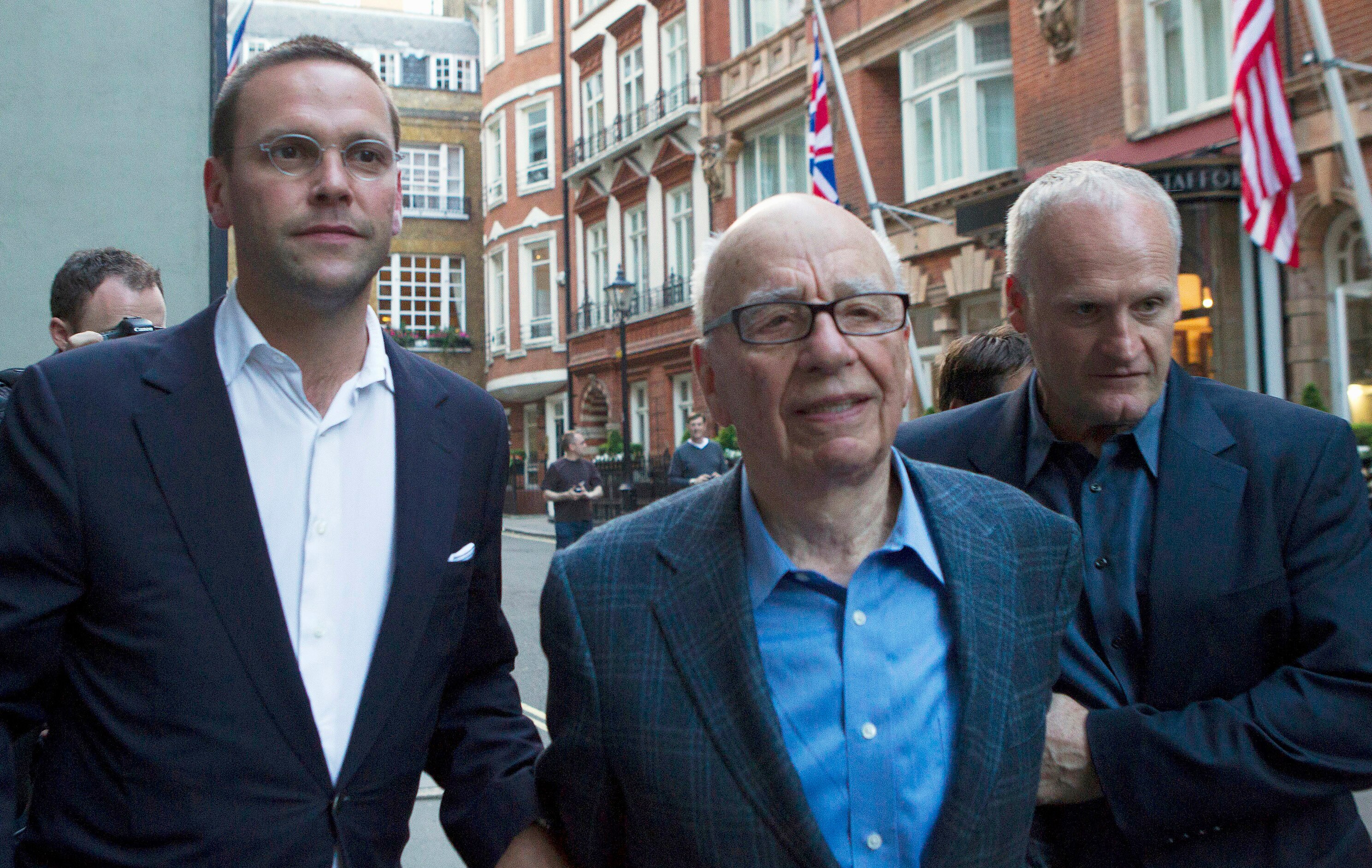 Rupert Murdoch and his son James walking down a London street, looking uncomfortable 