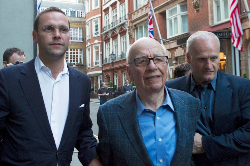 Rupert Murdoch and his son James walking down a London street, looking uncomfortable 